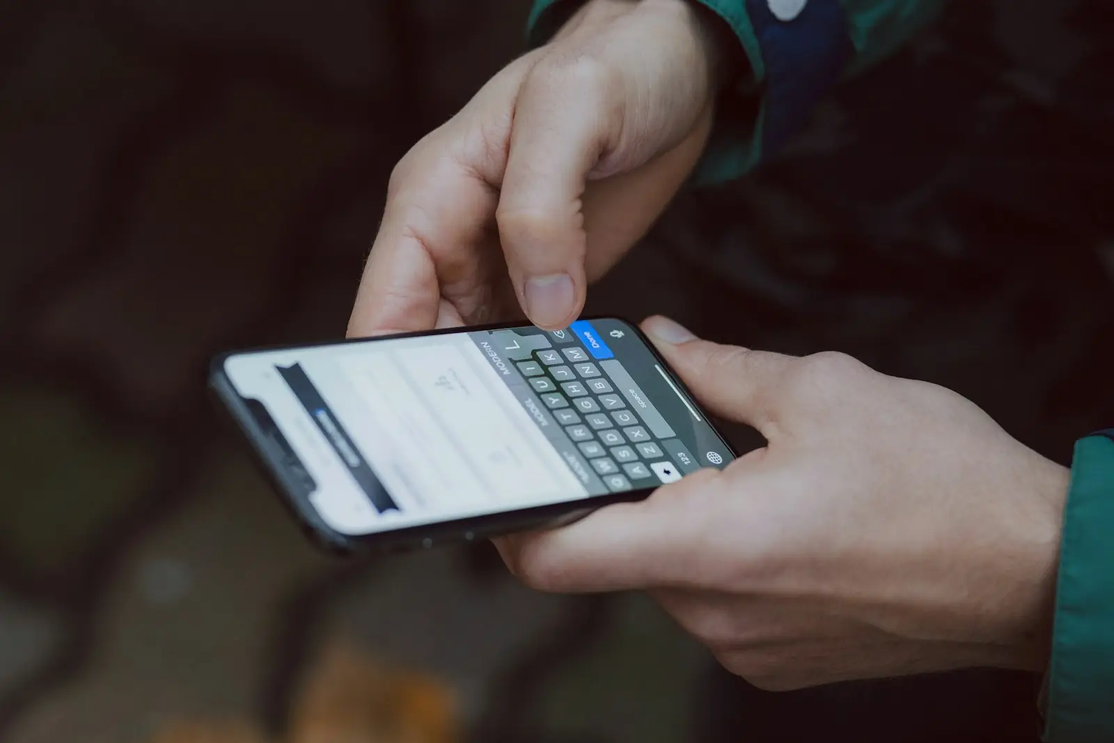 A person typing a message on a smartphone