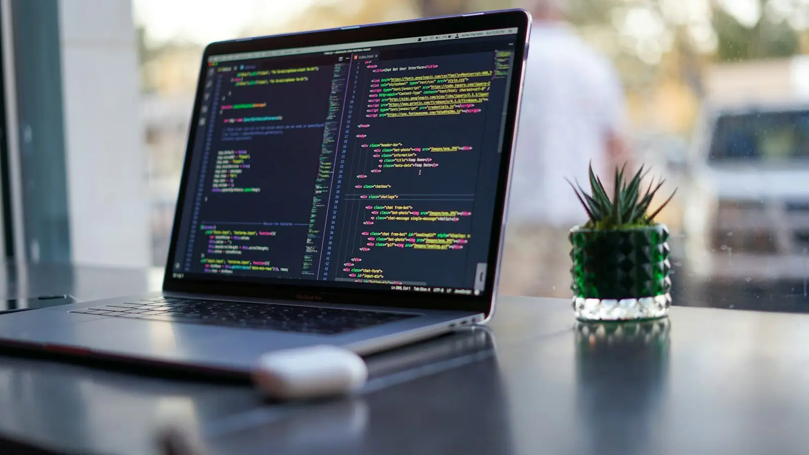 A laptop showing code on a desk